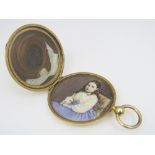 An engine turned picture locket containing a portrait and lock of hair, 4.4cm diameter, 27.9g