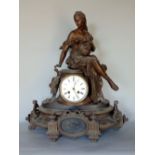 Late 19th century French spelter figural mantle clock, the two train 4 inch enamel dial mounted with