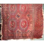 An Afghan red ground saddle bag with lozenge shaped medallions within further geometric panels, 80 x