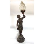 French bronzed spelter figural table lamp of a robed female holding a torch, glass shade, 94 cm high