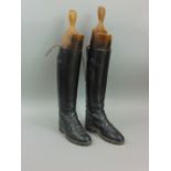 A pair of black leather early 20th century Regent hunting boots, size 6.5 with wooden trees