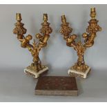 A pair of good quality heavy cast brass two branch table lamps with cornucopia, mermaids, bull