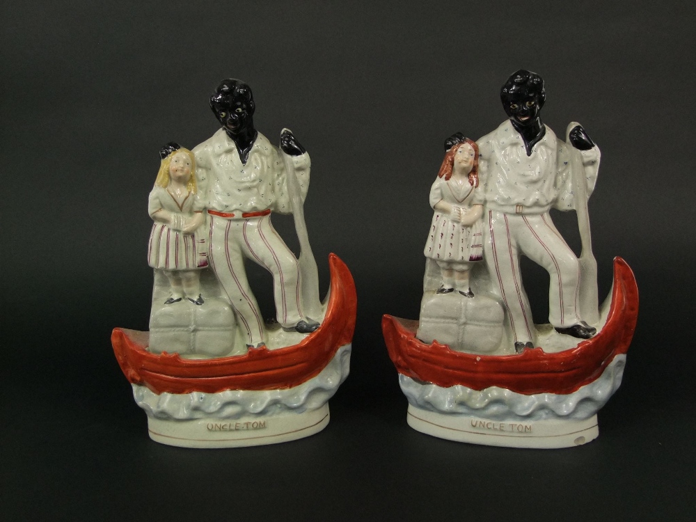 Two 19th century figure groups of Uncle Tom and Little Eva on a boat, both with titles to base, 32