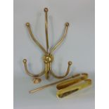 A mixed collection of brassware to include a three prong coat hook, two shoe horns and other