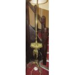 A gilded brass telescopic lamp standard supporting a hexagonal onyx tray raised on a tripod base,