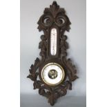 Attractive barometer/thermometer with carved scrolled leaf frame and open working, with mercury