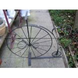 A novelty iron work flower pot stand in the form of a penny farthing bicycle