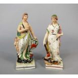 A pair of early 19th century Staffordshire classical allegorical female figures, both raised on