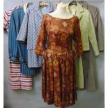 A collection of vintage ladies clothing from the 1950s to 70s including dresses, two piece suits and