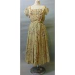 A ladies dress with Harrods label size 13 with sheer printed fabric over a peach coloured underskirt