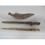 An eastern brass dagger with lizard skin handle, a further Kukri with leather scabbard and a WWI