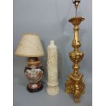 Three various table lamps to include one resin lamp decorated with an internal cathedral scene, a