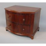 Apprentice mahogany bow front chest of drawers, the moulded top over two long drawers on bracket