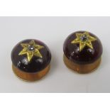 A pair of cabochon garnet dress studs, each set with a diamond within star cut surround, in unmarked