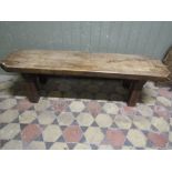 A rustic oak pig type bench with canted corners and square cut supports, 5ft long approx