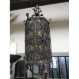 A hexagonal porch/hall lantern with yellow tinted glazed panels and tied scrollwork detail
