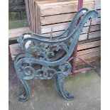 A pair of Victorian style cast iron bench ends with lions mask and decorative scroll work detail