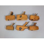 Six 19th century miniature boxwood woodworking smoothing planes, all stamped G Hallan - 10cm long