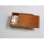 A set (complete) miniature bone domino's - 28 pieces in a small mahogany box, each domino 2cm long