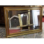 An oval gilt framed wall mirror with raised scrolling acanthus and bead work detail, 65 cm x 55 cm