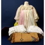 A box of mixed textiles and vintage clothing including a child's cotton dress, white cotton