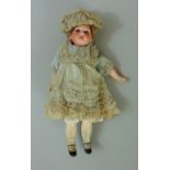 A small bisque headed doll, size 10 inches, mould number 2300 in original clothing of dress, hat,