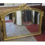 A reproduction gilt framed overmantle mirror of rectangular arched geometric form, with moulded