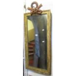 A 19th century wall mirror of rectangular form, the distressed gilt frame with beaded slip,