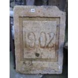 A reclaimed carved natural stone architectural tablet dated 1902, 65 cm x 45 cm, together with one