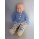 A small doll by Gebruder Knoch, with bisque head and shoulders on a soft body, size 14 inches,