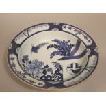 A early 19th century Chinese wash bowl of shallow form, with blue and white painted decoration of