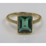 An 18ct ring set with green glass, size I, 2.1g