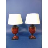 Pair of bronzed faceted baluster table lamps, upon stepped square bases, 43cm high (with shades)