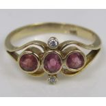 A 14ct pink ruby and diamond ring of stylised form, size L, 2.7g