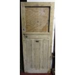 A reclaimed Victorian stripped pine front door, with moulded panels beneath a now vacant probably