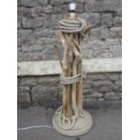 A nautical theme outsized table lamp with rope bound drift wood column and coiled disc shaped