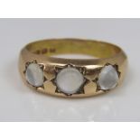 A 15ct Gypsy ring set with three moonstones in star surround, size P, 5.2g