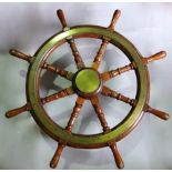 Teak and brass ships wheel, with eight turned handles around a central brass roundel, 78 cm