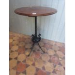 A Victorian cast iron table base with fluted column and swept tripod supports with dragons head