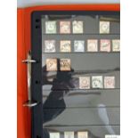 A collection of early German States stamps in a folder, mint and used (displayed in cabinet)