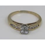 A 14k princess style diamond ring with channel set diamond shoulders, size Q, 3.4g