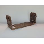 Black Forest oak carved book slide, the hinged ends pierced with grapevines, 40cm long (adjustable)