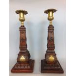 A good pair of treen and gilt brass candlesticks, of square tapered form, carved with Masonic