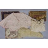 A collection of textiles to include two bed jackets, a cape, a sheepskin collar, two Eastern style