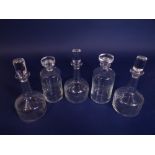 A set of five various glass decanters, all with geometric etched band, to include three ship type