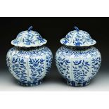 A pair of Chinese blue and white vases and covers in the Kangxi manner of globular form with painted