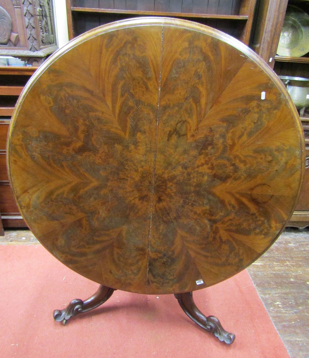 A mid-Victorian period mahogany centre table, the circular top with well matched segmented flamed
