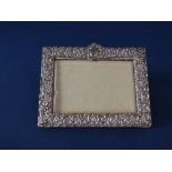 Probably Edwardian silver applied easel photograph frame, decorated with floral sculpt cartouche and