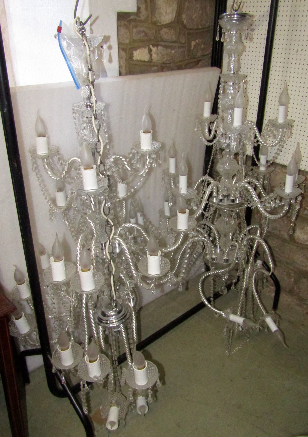 A pair of impressive moulded glass chandeliers (electrified), the faceted stems supporting