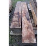 Two mill sawn soft wood blocks approx 240 cm long x 32 cm square (possibly cedar)